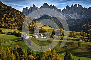 Church of St. Magdalena in front of the Geisler or Odle Dolomites mountain peaks. Val di Funes in South Tyrol. Italy.