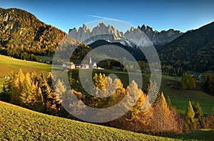 Church of St. Magdalena in front of the Geisler or Odle Dolomites mountain peaks. Val di Funes valley in Italy.