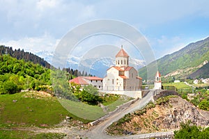 Church of St. Nicholas on the hill of mountains background in Mestia, Georgia