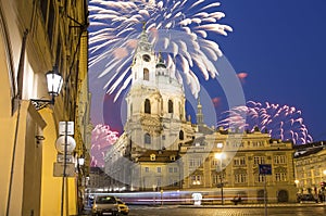 Church of St. Nicholas (Night view ) in the quarter of Mala Strana in Prague and holiday fireworks, Czech Republic