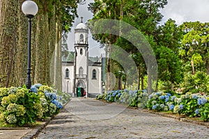 Church of St. Nicholas in Sete Cidades Azores surrounded by two rows of trees