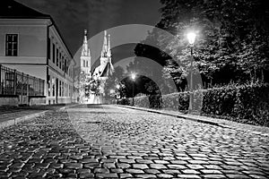 Church of St. Peter and Paul on Vysehrad. Cobbled street by night. Prague, Czech Republic