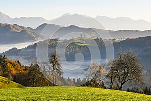 The church of St. Thomas at sunrise im autumn, Skofja Loka, Slovenia photo