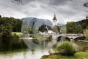 Church steeple building old bridge, Bohinj lake Slovenia