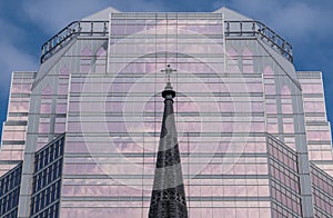 Church steeple in front of stylish modern office building