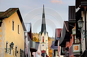 Church steeple rises above main street in Garmisch Germany