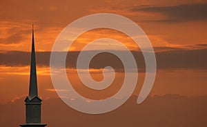 Church steeple set against sunset