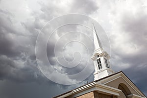 Church Steeple Tower Below Ominous Stormy Thunderstorm Clouds.