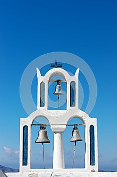Church with three bells in the town of Fira Santorini
