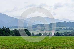 Church tower on the background of the tatra mountains