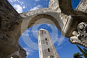 Church tower framed by stone arcs