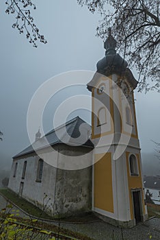 Church with tower in Petrovice village in autumn morning near Usti nad Labem