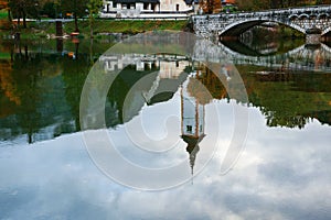 Church tower and stone bridge at Lake Bohinj