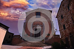 church in the tuscan town of lucignano at sunset