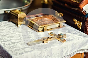 church utensil on an altar, glans, cross on the church altar,the Bible on the table,ceremony of water baptism,Orthodox priest photo