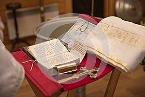 Church utensil on an altar, glans, cross on the church altar,the Bible on the table, ceremony of water christening