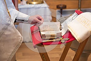 Church utensil on an altar, glans, cross on the church altar,the Bible on the table, ceremony of water christening