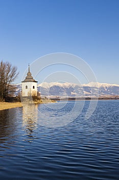 Church of Virgin Mary in Havranok and lake Liptovska Mara, district Liptovsky Mikulas, Slovakia