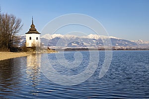 Church of Virgin Mary in Havranok and lake Liptovska Mara, district Liptovsky Mikulas, Slovakia