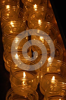 Church votive prayer candles in jars photo