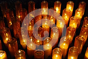 Church votive prayer candles in jars photo