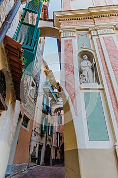 Church wall statue and street view in the beautiful village of Dolceacqua, Italy