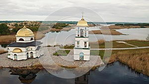 Church on the water in the rays of the rising sun