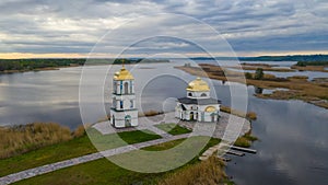 Church on the water in the rays of the rising sun