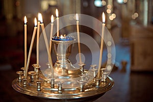 Church. Wax candles. Lighted candles in the church, close-up, prayer, for the maintenance of the soul, for health, joy, happiness
