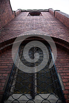 Church window and brick wall upwards perspective