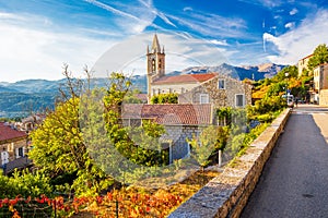 Church in Zonza village with typical stone houses during sunset, Corsica island, France, Europe.