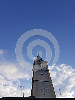 Churche tower against blue sky and clouds photo