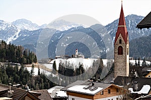 The churches of Mareo in the Dolomites, also known as Enneberg Pfarre and of  the hamlet Costa photo