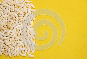 Churmure or murmure or moori, Puffed rice, food ingredient. Traditional food isolated on yellow background