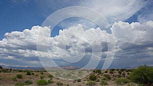 Churning Cumulus Clouds over Desert Landscape Timelapse