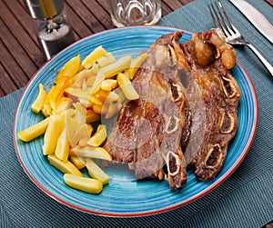 Churrasco de ternera, grilled veal spare ribs with fries photo