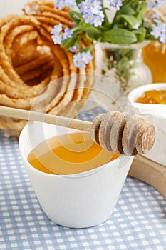 Churro donuts and bowl of honey