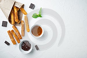 Churros with caramel Traditional Spanish cusine  on white background  top view flat lay with space for text  copyspace