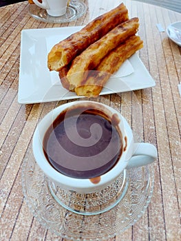 Churros with chocolate. Spanish breakfast. Candy. Sugar. Cholate.