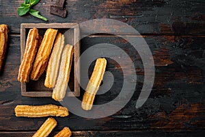 Churros with chocolate Traditional Spanish cusine  on old dark wooden table background  top view flat lay with space for text