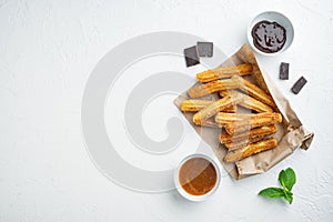 Churros with chocolate Traditional Spanish cusine  on white background  top view flat lay with space for text  copyspace