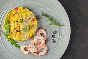 The chutney is neatly laid out on a gray plate. Near fresh shrimp. Delicious mango sauce with hot chili peppers