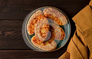 Chvishtari, corn flour tortillas with cheese, pastries, Georgian cuisine, Mchadi, homemade, top view, on a wooden table