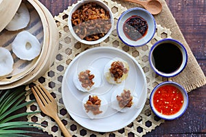 Chwee Kueh - Steamed rice cake top with preserved turnip served with sweet soy sauce and chili sauce