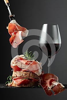 Ciabatta with prosciutto, rosemary and glass of red wine