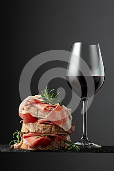 Ciabatta with prosciutto, rosemary and glass of red wine