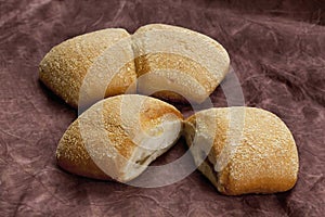 Ciabatta rolls on dessert stand, vertical photo.