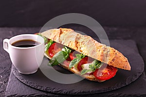 Ciabatta sandwich with caprese salad with coffee.