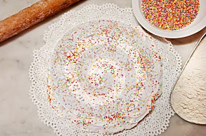 The ciaramicola is a typical Umbrian Easter cake; it is a donut-shaped cake, red in color with white icing and colored topping spr