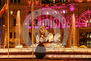 Cibeles fountain illuminated at night in Madrid, Spain.